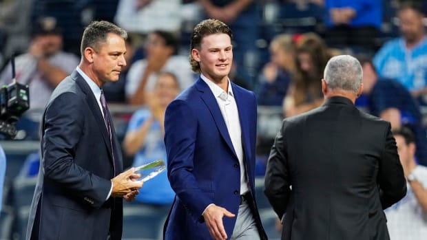 Oct 1, 2021; Kansas City, Missouri, USA; Kansas City Royals minor league shortstop Bobby Witt Jr. receives the Royals Minor League Hitter of the Year Award from general manager J.J. Picollo and president Dayton Moore before the game against the Minnesota Twins at Kauffman Stadium. Mandatory Credit: Jay Biggerstaff-USA TODAY Sports